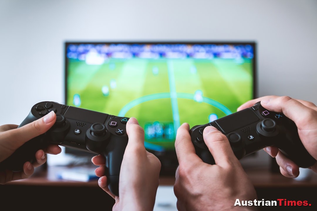 two people playing Sony PS4